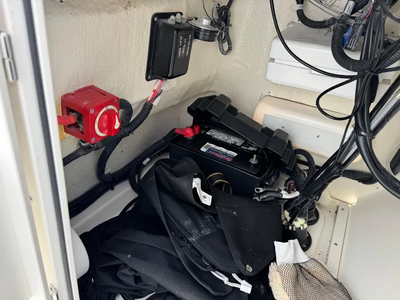 Slide: The Image of 2023 Boston Whaler 170 Montauk boat interior showing battery and wiring components. - 27