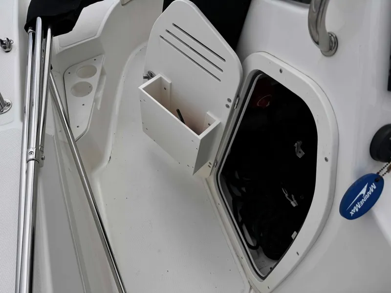 Slide: The Image of 2023 Boston Whaler 170 Montauk boat storage compartment with open hatch and organizer. - 28
