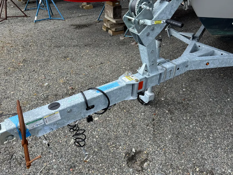 Slide: The Image of Trailer hitch of a 2023 Boston Whaler 170 Montauk on gravel surface. - 29