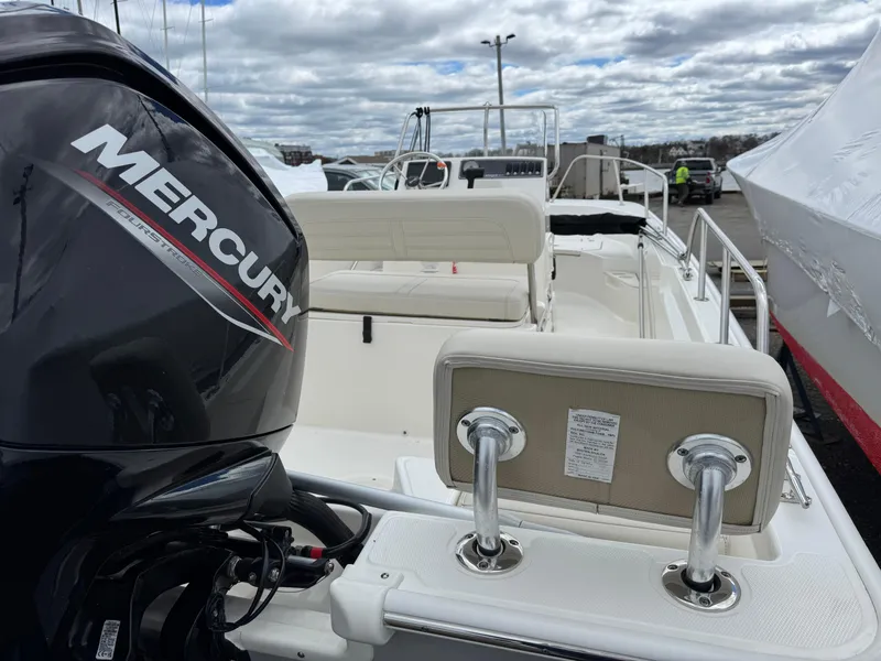 Slide: The Image of 2023 Boston Whaler 170 Montauk with Mercury engine, docked under cloudy skies. - 4