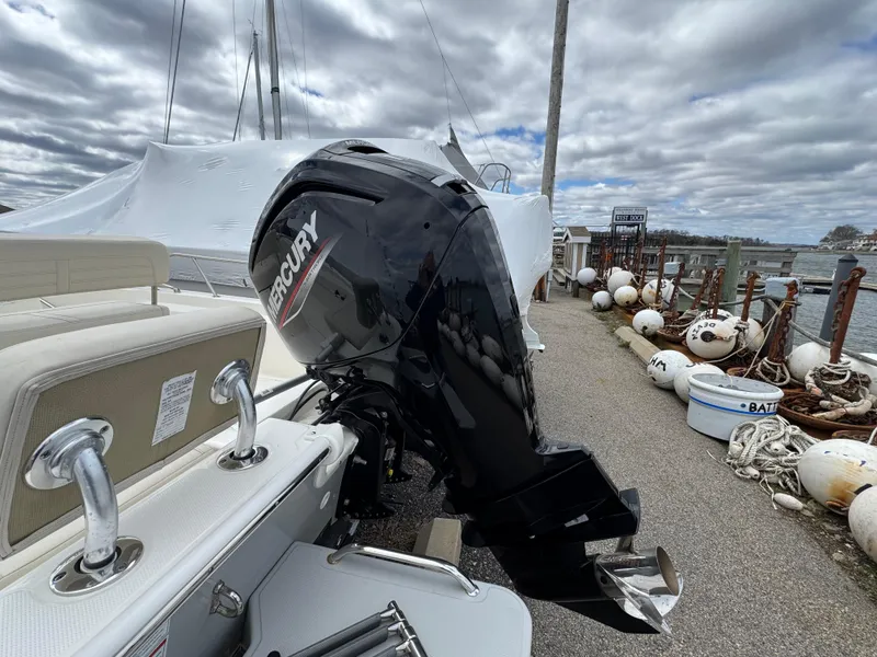 Slide: The Image of 2023 Boston Whaler 170 Montauk with Mercury outboard motor docked by the marina. - 7