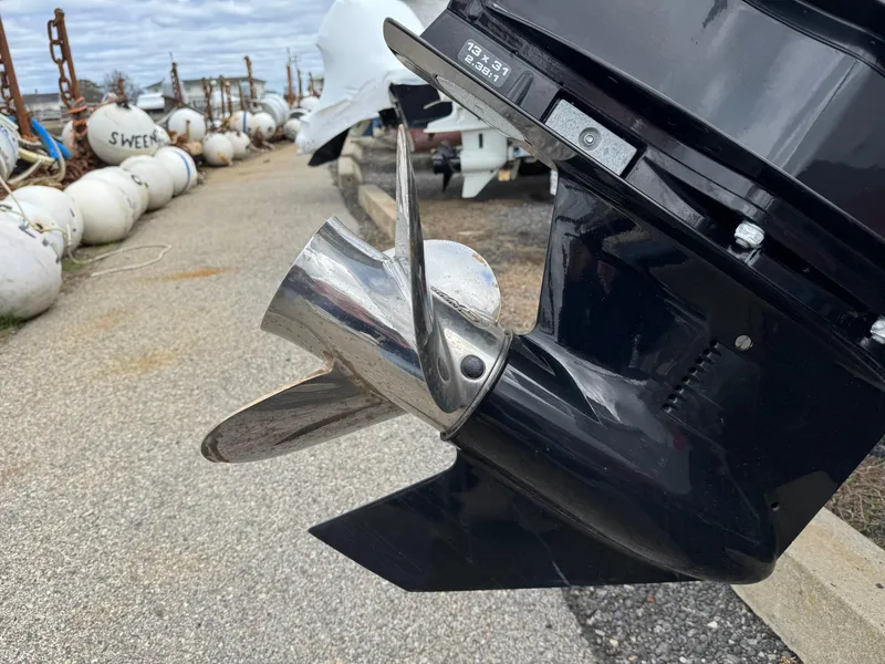 Slide: The Image of Outboard motor propeller of a 2023 Boston Whaler 170 Montauk boat, dockside view. - 8