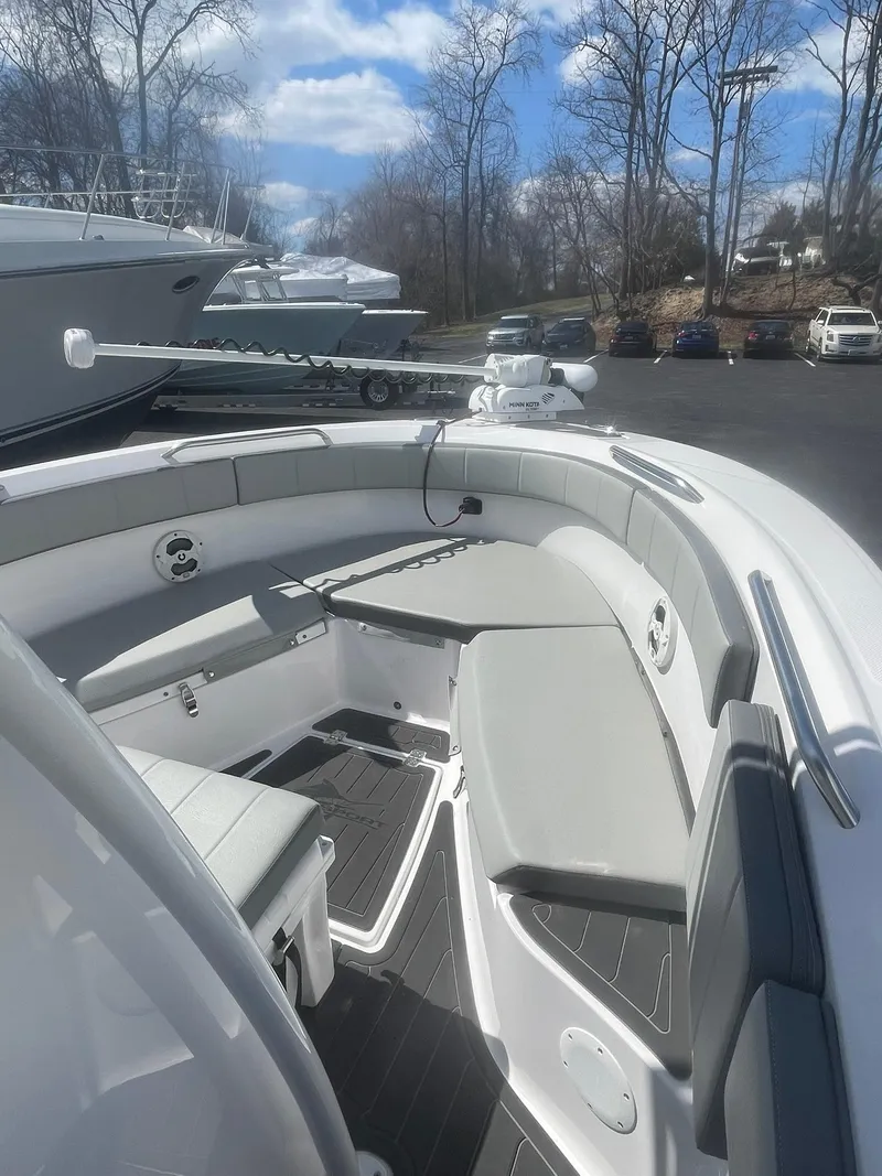 Slide: The Image of 2022 Aquasport 2100 CC boat interior with cushioned seating and sleek design. - 16