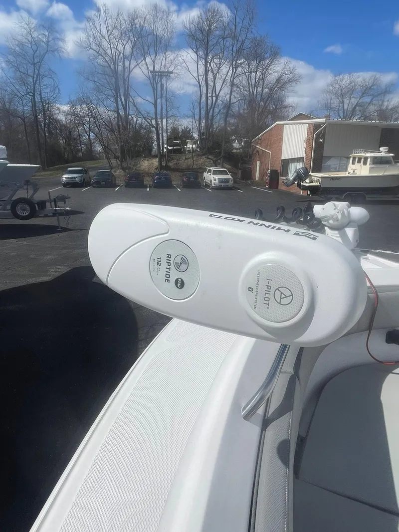 Slide: The Image of Close-up of a 2022 Aquasport 2100 CC boat's control panel on a sunny day. - 20