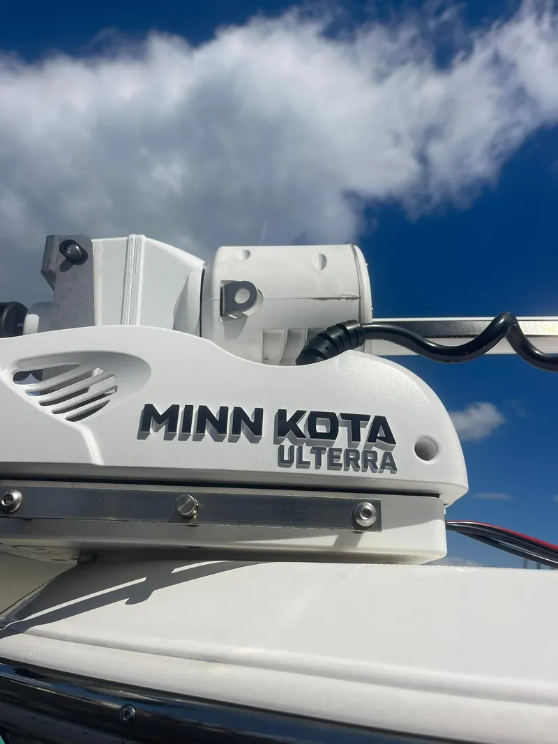 Slide: The Image of Minn Kota Ulterra motor on 2022 Aquasport 2100 CC boat under blue sky. - 3