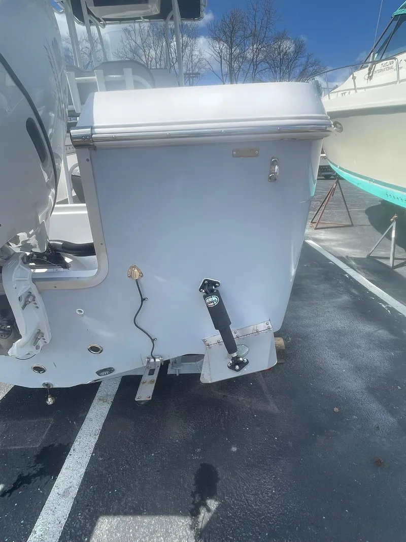 Slide: The Image of 2022 Aquasport 2100 CC boat stern view in a parking lot. - 9