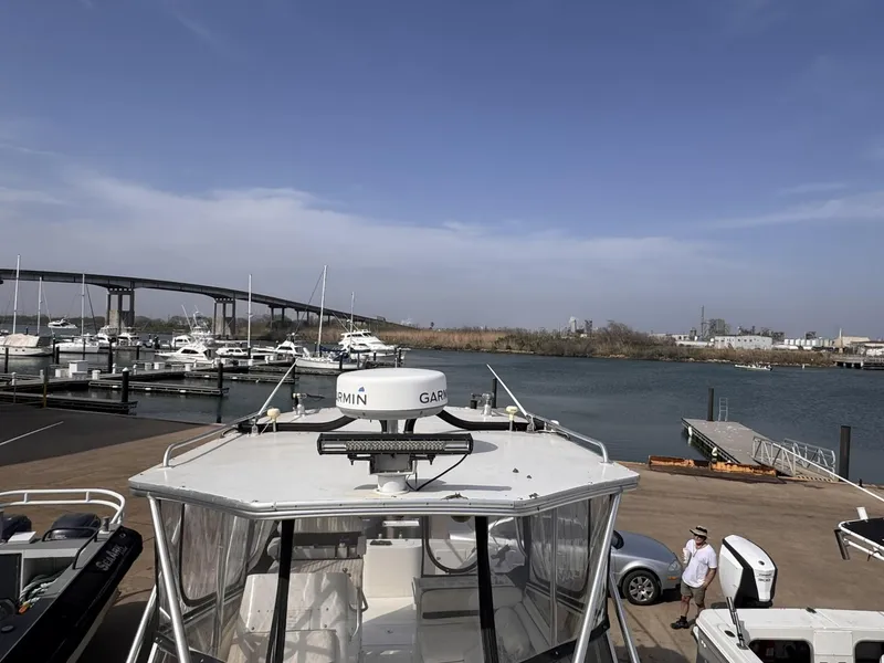 Slide: The Image of 1998 Contender 35 Express Side Console at marina with bridge and waterfront view. - 15