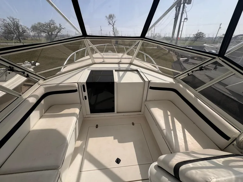 Slide: The Image of 1998 Contender 35 Express Side Console interior with white seating and panoramic windows. - 16