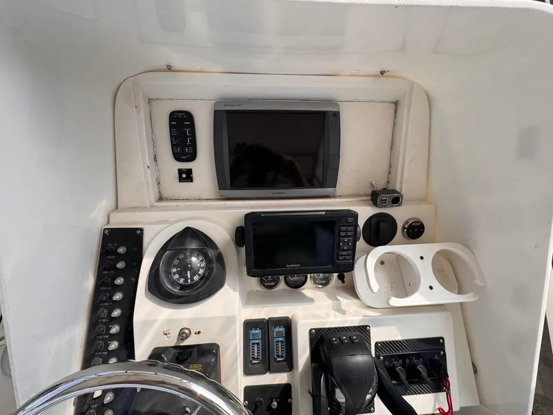 Slide: The Image of Control panel of a 1998 Contender 35 Express Side Console boat with navigation instruments. - 18