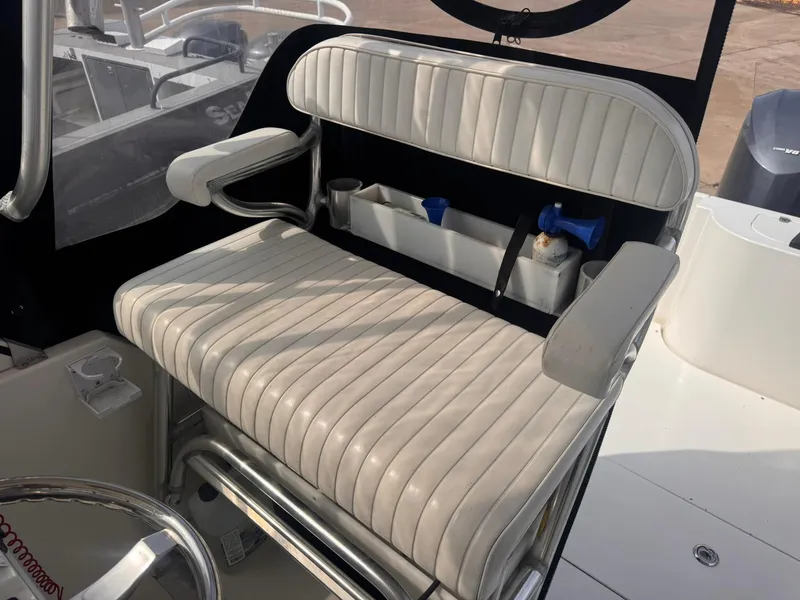 Slide: The Image of Contender 35 Express Side Console 1998 boat seat with storage and armrests. - 20
