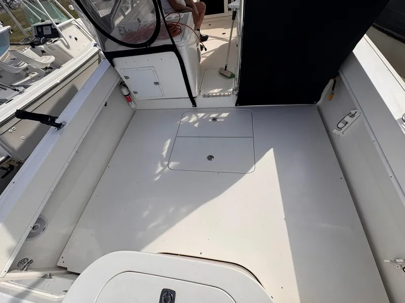 Slide: The Image of 1998 Contender 35 Express Side Console boat interior, featuring spacious deck and seating area. - 22