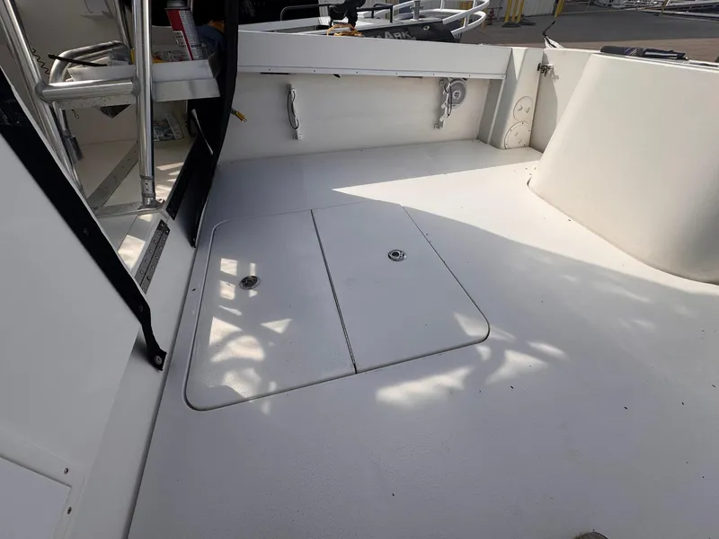 Slide: The Image of 1998 Contender 35 Express Side Console boat deck with storage hatch and seating area. - 23