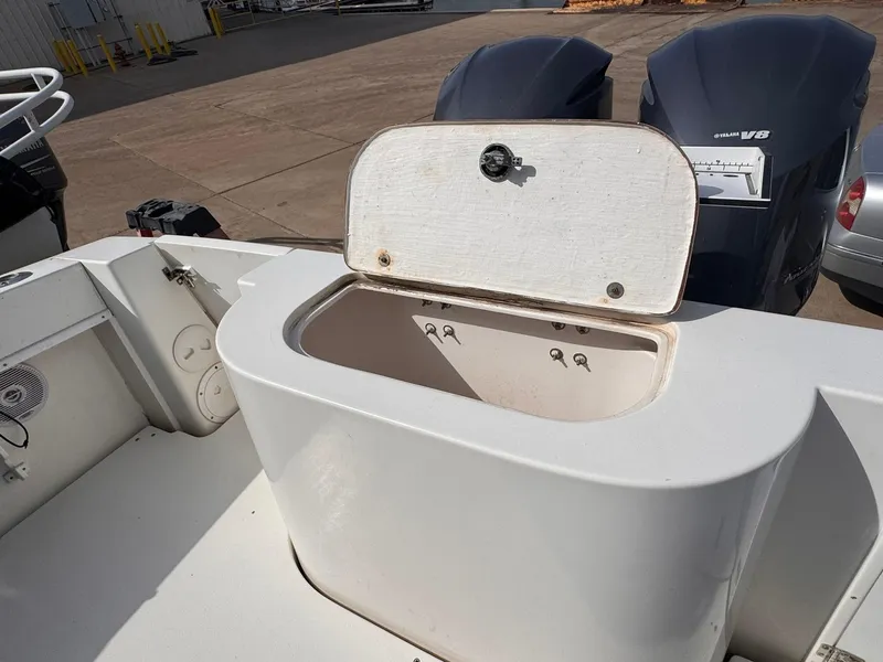 Slide: The Image of 1998 Contender 35 Express Side Console with open storage compartment and dual outboard engines. - 24