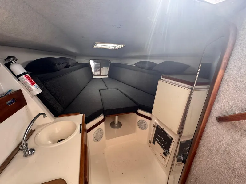 Slide: The Image of 1998 Contender 35 Express Side Console cabin with sink, seating, and storage. - 25