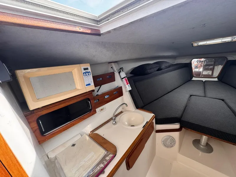 Slide: The Image of Interior of 1998 Contender 35 Express Side Console with kitchenette and seating area. - 26