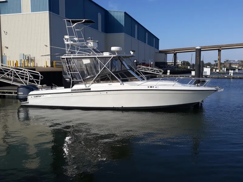 Slide: The Image of 1998 Contender 35 Express Side Console boat docked at marina, clear day. - 3