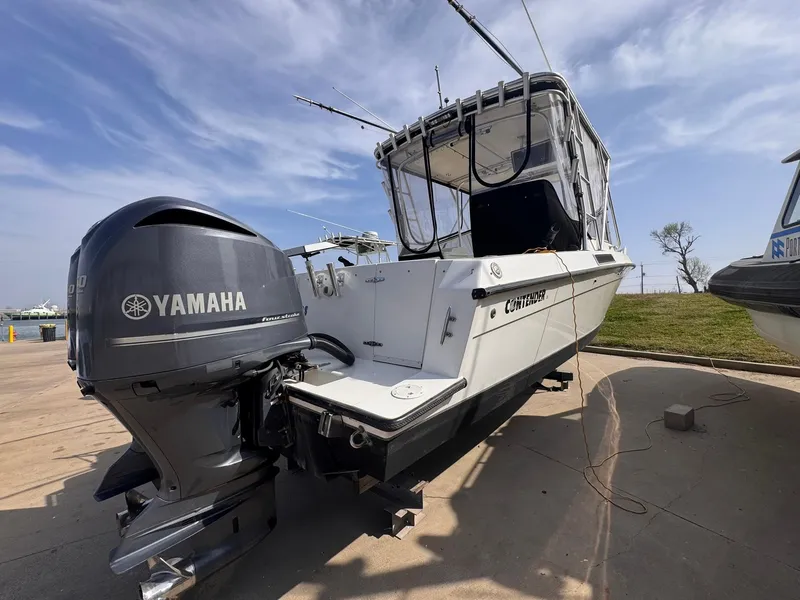 Slide: The Image of 1998 Contender 35 Express Side Console boat with Yamaha outboard motor, docked outdoors. - 8