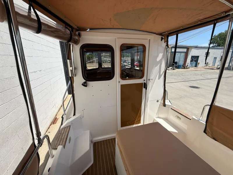 Slide: The Image of Interior view of 2016 Ranger Tugs R-21 EC boat with seating and windows. - 10