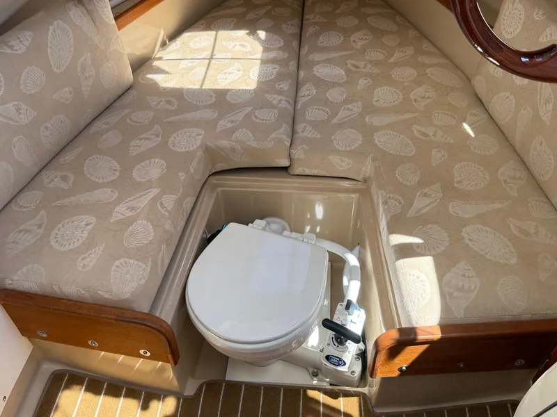 Slide: The Image of 2016 Ranger Tugs R-21 EC cabin interior with patterned cushions and marine toilet. - 14