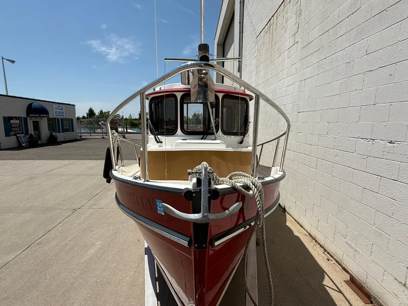 Slide: The Image of 2016 Ranger Tugs R-21 EC boat docked beside a building under a clear blue sky. - 20