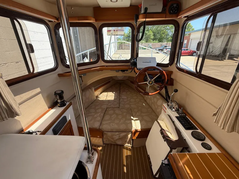 Slide: The Image of 2016 Ranger Tugs R-21 EC interior with helm, seating, and navigation equipment. - 6