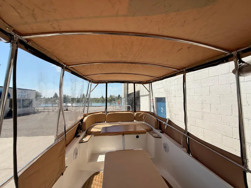 Slide: The Image of 2016 Ranger Tugs R-21 EC boat interior with canopy and seating. - 8