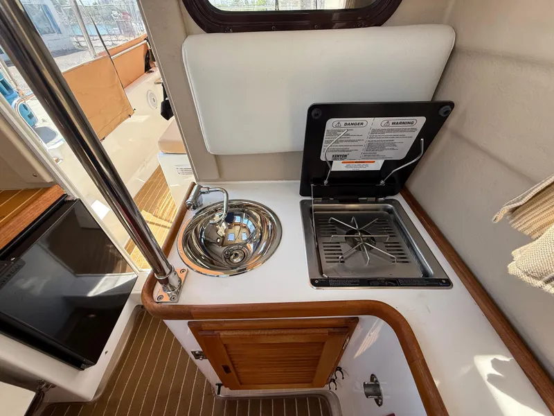 Slide: The Image of 2016 Ranger Tugs R-21 EC interior with compact kitchen sink and stove. - 9