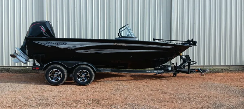 Slide: The Image of 2024 Ranger VX1888 WT boat on trailer, black exterior, parked outdoors. - 0
