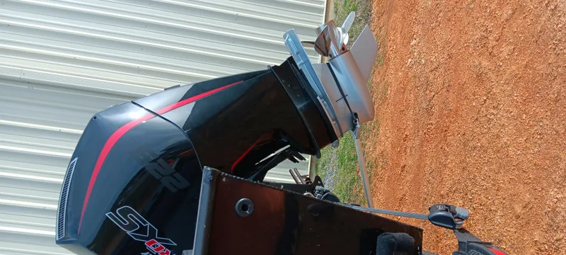 Slide: The Image of 2024 Ranger VX1888 WT boat engine, black with red accents, on a gravel surface. - 10