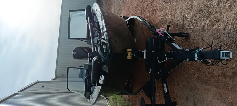 Slide: The Image of 2024 Ranger VX1888 WT boat on trailer, parked outdoors near a building. - 11