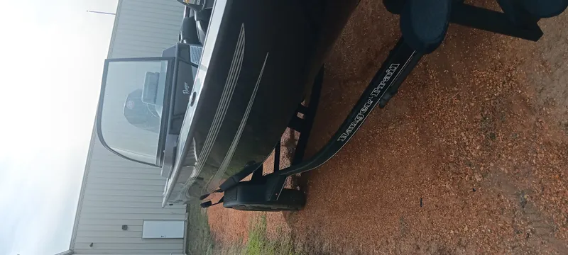 Slide: The Image of 2024 Ranger VX1888 WT boat on trailer, parked outdoors near a building. - 12