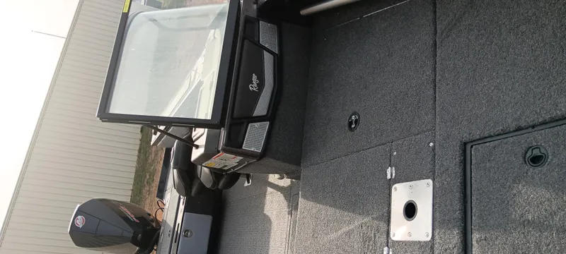 Slide: The Image of 2024 Ranger VX1888 WT boat interior with windshield and motor, showcasing sleek design and functionality. - 15