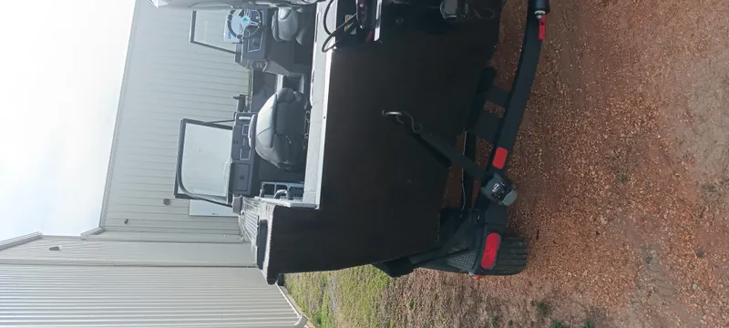 Slide: The Image of 2024 Ranger VX1888 WT boat on trailer near metal building. - 2