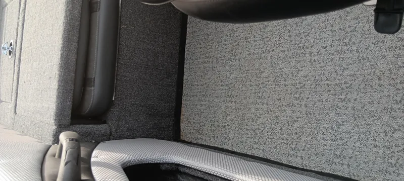 Slide: The Image of 2024 Ranger VX1888 WT boat interior with gray carpet and seating. - 22