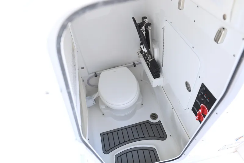 Slide: The Image of 2025 Sea Hunt Ultra 265 SE boat interior with compact marine toilet. - 11