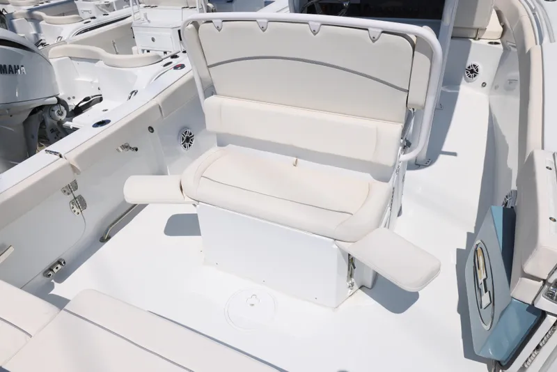 Slide: The Image of 2025 Sea Hunt Ultra 265 SE boat interior with white seating and storage. - 13