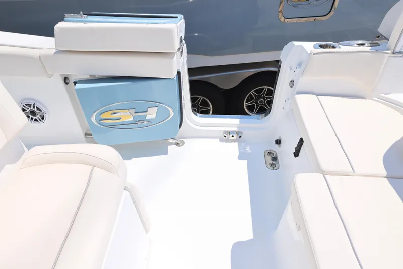 Slide: The Image of 2025 Sea Hunt Ultra 265 SE boat interior with white seating and storage compartments. - 14