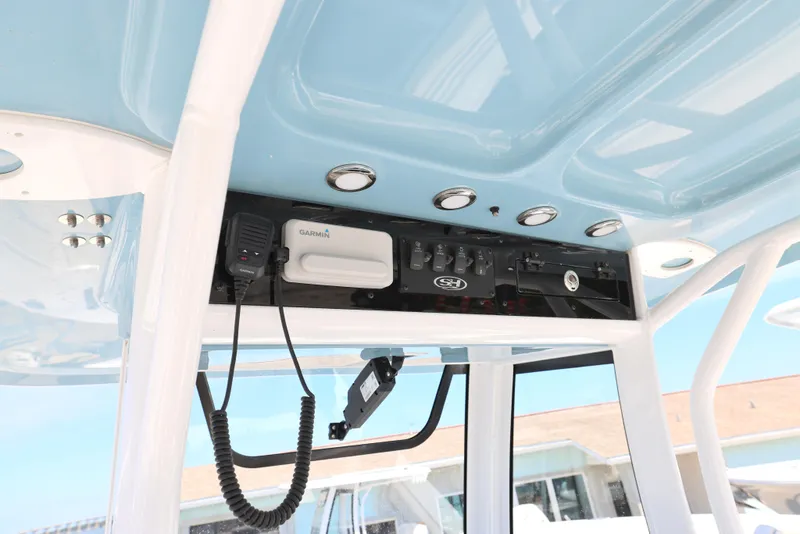Slide: The Image of 2025 Sea Hunt Ultra 265 SE boat console with electronic controls and communication equipment. - 15