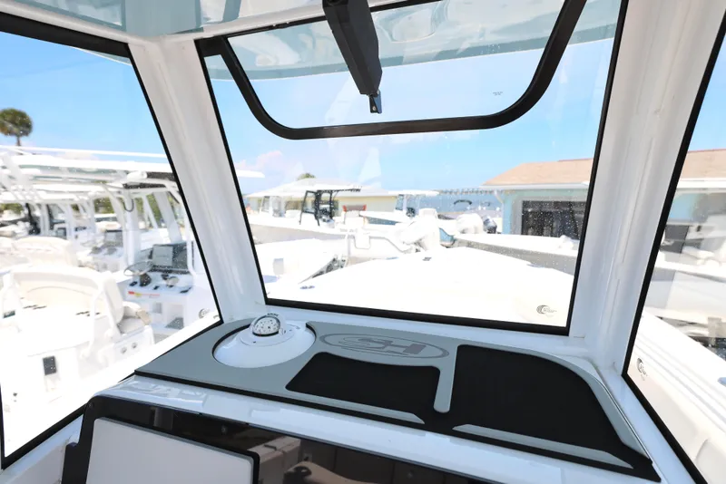 Slide: The Image of 2025 Sea Hunt Ultra 265 SE boat interior with modern dashboard and panoramic windows. - 16