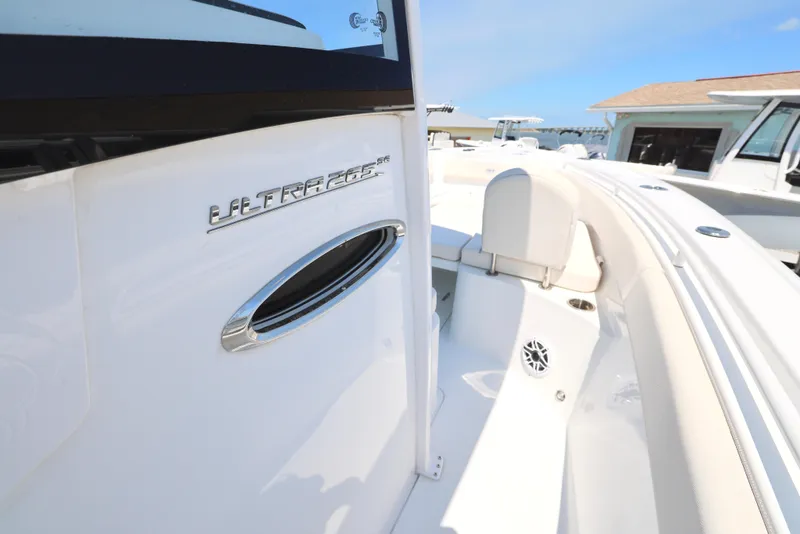 Slide: The Image of 2025 Sea Hunt Ultra 265 SE boat, sleek white design, modern features, sunny day. - 19