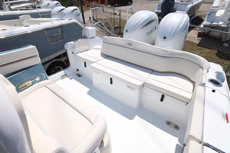 Slide: The Image of 2025 Sea Hunt Ultra 265 SE boat interior with white seating and storage compartments. - 2