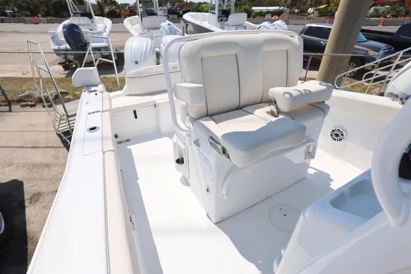 Slide: The Image of 2025 Sea Hunt Ultra 265 SE boat interior with white seating and console. - 6