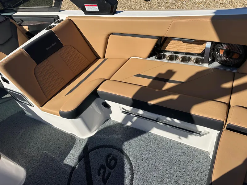 Slide: The Image of 2023 MasterCraft X26 interior with tan leather seating and cup holders. - 10