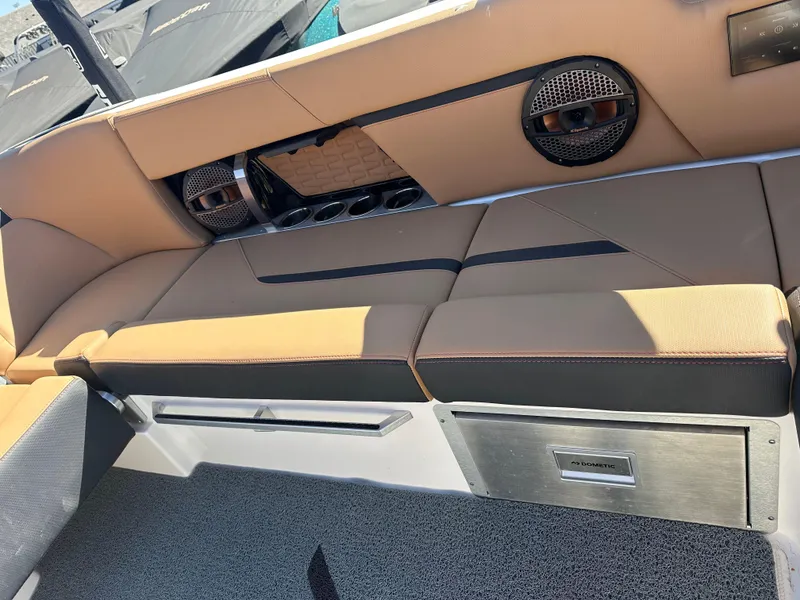 Slide: The Image of 2023 MasterCraft X26 interior seating with built-in speakers and storage. - 9