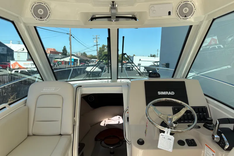 Slide: The Image of Interior view of 2026 Boston Whaler 285 Conquest boat cockpit with steering wheel and controls. - 10