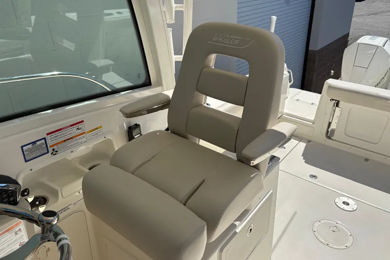 Slide: The Image of Captain's chair on 2026 Boston Whaler 285 Conquest boat, featuring sleek design and comfort. - 12