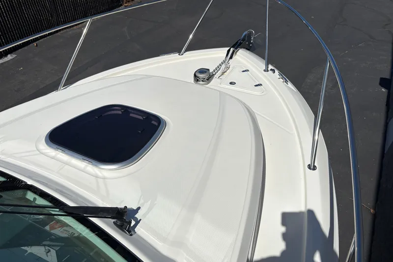 Slide: The Image of 2026 Boston Whaler 285 Conquest boat deck with hatch and railing, viewed from above. - 20