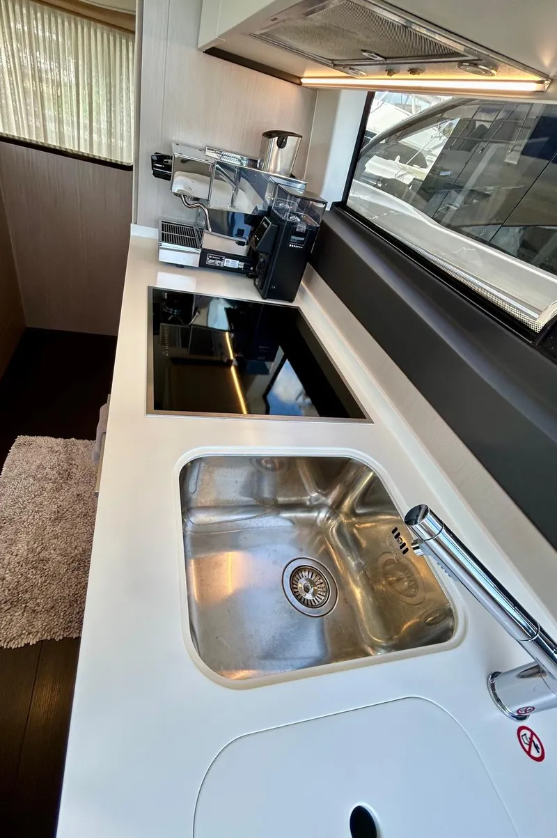 Slide: The Image of Modern kitchen in 2023 Azimut Fly 60 yacht with sleek appliances and stainless steel sink. - 11