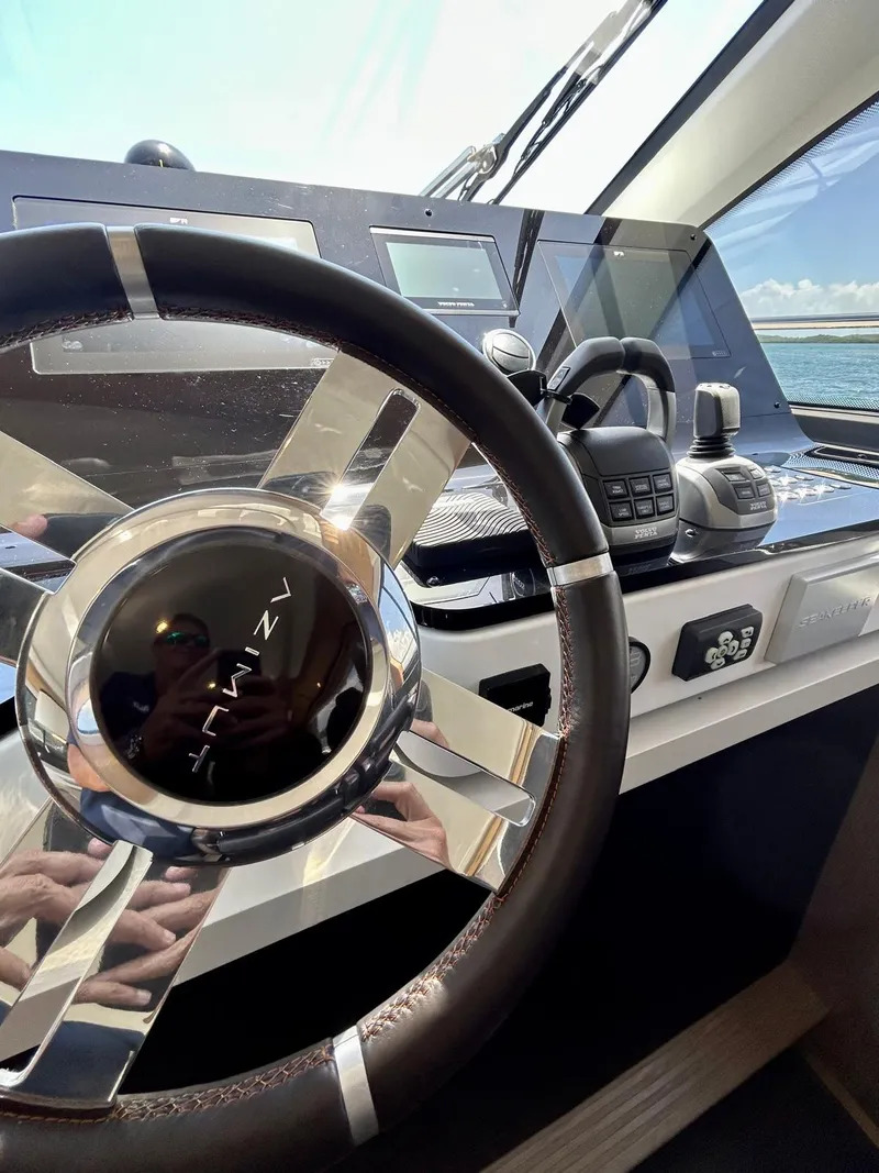 Slide: The Image of 2023 Azimut Fly 60 yacht helm with modern controls and steering wheel. - 22