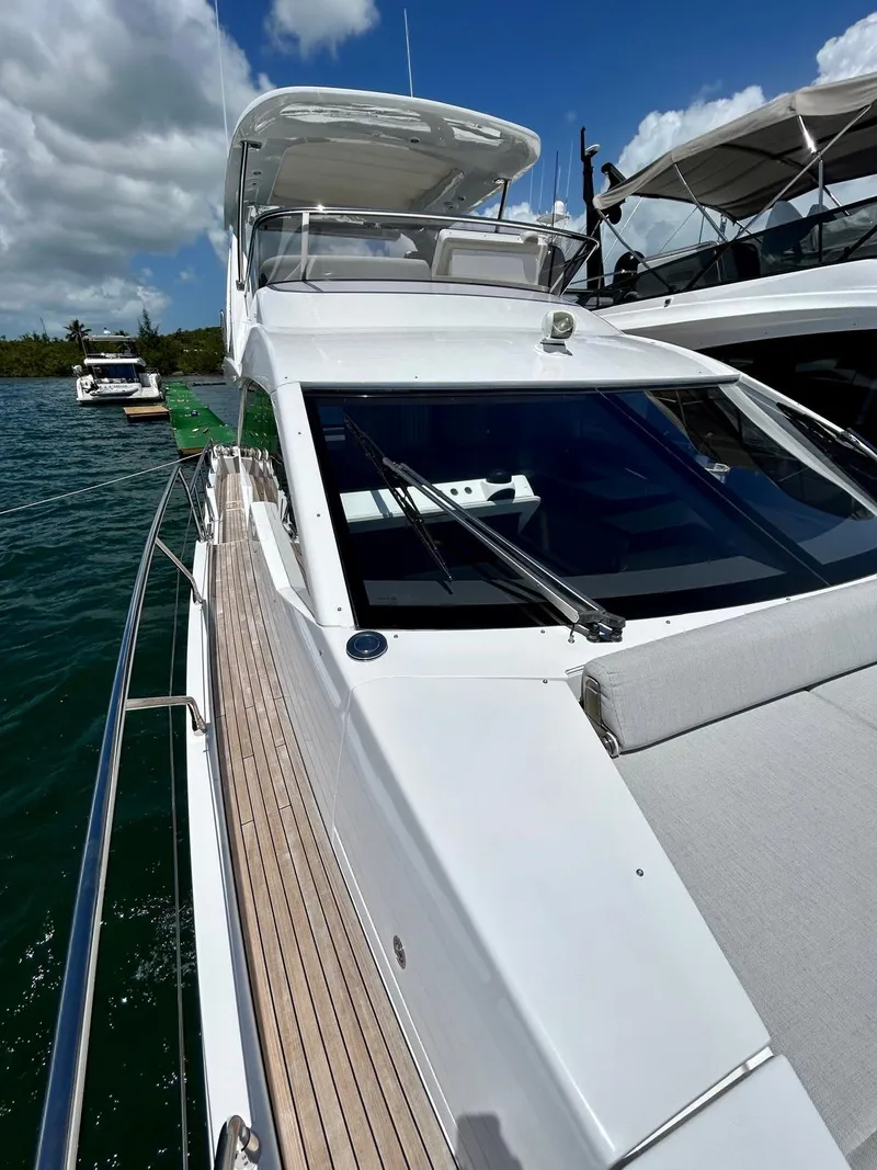 Slide: The Image of 2023 Azimut Fly 60 yacht with sleek design, docked on a sunny day. - 25